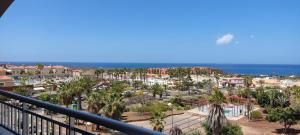 a view of a resort with the ocean in the background at Comfortable apartment with amazing sea views in Palm-Mar
