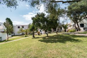 a large yard with trees and a building at Club Cala Domingos in Calas de Mallorca