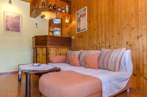 a living room with a couch and a table at Apartments and Rooms Darinka in Vrboska