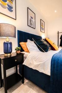 a bedroom with a bed and a table with a lamp at Dulwich House - Long Stay Offer - 2 mins to Station in London