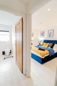 a bedroom with a bed with a blue and yellow blanket at Dulwich House - Long Stay Offer - 2 mins to Station in London