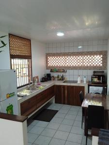 a kitchen with wooden cabinets and a table in it at MO TI KOTÉ in Cayenne