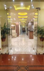 a lobby with a yellow ceiling and plants at HOTEL CITY PARK in Janakpur