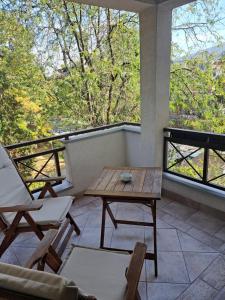 a room with a table and chairs and a balcony at A&A Apartment in Skopje