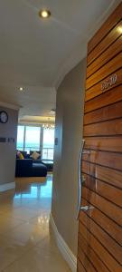 a lobby with a wooden door in a building at Ocean Sunrise at the Sails - Durban point waterfront in Durban