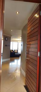 a hallway with a wooden door in a building at Ocean Sunrise at the Sails - Durban point waterfront in Durban