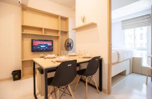 a dining room with a table and two chairs at Tokyo Riverside Apartment @ PIK 2 in Tangerang