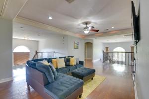 a living room with a couch and a flat screen tv at Elegant Houston Home with Gazebo and Game Room! in Houston