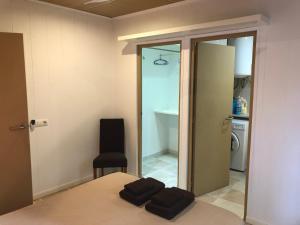 a bedroom with a bed and a chair and a mirror at Caballito de Mar in Roses