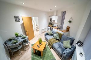 a living room with a couch and a table at 2-Bedroom Cozy Hideaway Close to Hollingworth Lake in Milnrow in Rochdale