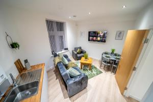 a living room with a couch and a table at 2-Bedroom Cozy Hideaway Close to Hollingworth Lake in Milnrow in Rochdale