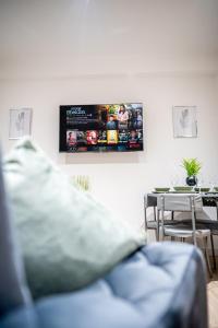 a living room with a blue couch and a table at 2-Bedroom Cozy Hideaway Close to Hollingworth Lake in Milnrow in Rochdale