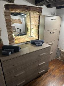 a large dresser in a room with a mirror at Casa Vacanza al Centro di Iglesias tra Mare e Miniere in Iglesias