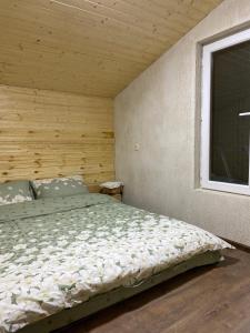a bedroom with a bed and a window at სასტუმრო ქორულდი / Hotel Koruldi in Mestia