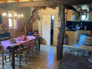 a dining room with a table and a kitchen at chalet st michel de maurienne in Beaune