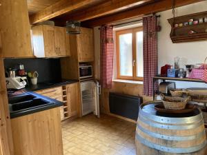 a kitchen with a barrel in the middle of it at chalet st michel de maurienne in Beaune