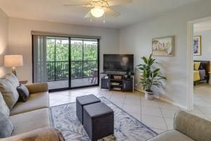 a living room with a couch and a tv at Pool, Hot Tub and Beach Access Cocoa Beach Home! in Cocoa Beach