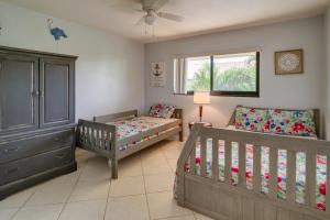 a nursery with two beds and a crib at Pool, Hot Tub and Beach Access Cocoa Beach Home! in Cocoa Beach +17 photos