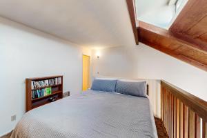 a bedroom with a bed and a book shelf at Sugar Shack in Carpinteria