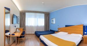 Postel nebo postele na pokoji v ubytování Hotel Express Aosta East