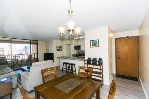 a living room with a dining table and a kitchen at Discovery Bay 2308 condo in Honolulu