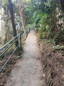 a path leading up a hill with a fence at Asaf place in Haifa
