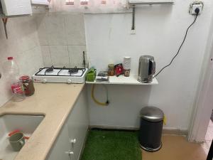 a small kitchen with a sink and a stove at Asaf place in Haifa