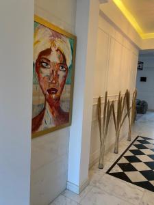 a painting of a woman on a wall in a hallway at Luxury Allegria Golf Villa with pool in Sheikh Zayed