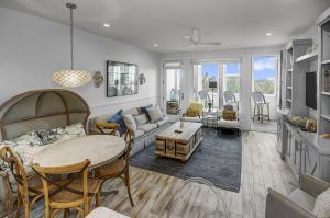 a living room with a couch and a table at Beach and Gulf Views from the Center of Seaside! condo in Santa Rosa Beach