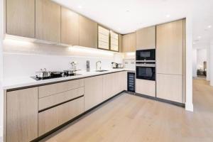 a large kitchen with wooden cabinets and appliances at *Rare Find* Luxury London Collection in London