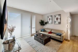 a living room with a couch and a coffee table at 5 Heart of Santa Monica apartment in Los Angeles