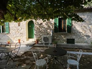 a patio with tables and chairs in front of a building at San Rocco Country House in Pesaro