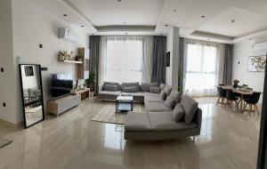 un ampio soggiorno con divano e TV di شقق عبية الفندقية a Riyad