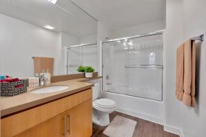 a bathroom with a toilet and a glass shower at 6 Modern 2 bdr apartment Santa Monica pier in Los Angeles