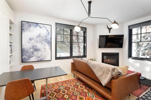 a living room with a couch and a table at Christiana Lodge 102A Studio in Aspen with Hot Tub access in Aspen