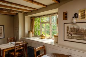a dining room with a table and a window at The Ebrington Arms in Chipping Campden