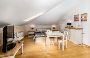 a bedroom with a bed and a table with a desk at Hostel Koral in Szczecin