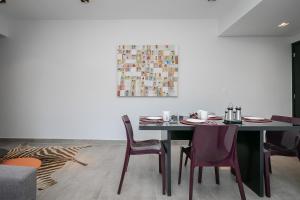 uma sala de jantar com uma mesa e cadeiras e um quadro em Moderno apartamento, 2 quartos em Belo Horizonte