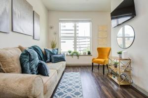 a living room with a couch and a chair at Luxury Living Downtown Houston Kingbed. in Houston