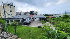 una vista de una casa con patio en Jeju stay Jeong, en Seogwipo