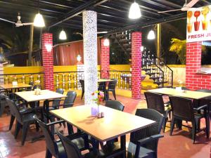 a restaurant with tables and chairs in a room at Veronica By The Beach Calangute in Calangute