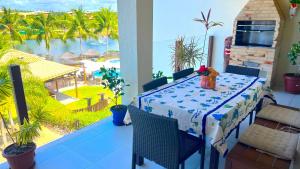 a table on a balcony with a view of the ocean at Apartamento com varanda no Iberostate em Praia do Forte in Praia do Forte