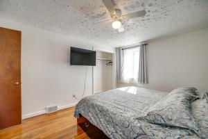 a bedroom with a bed and a flat screen tv at Pittsburgh Townhome about 5 Miles to Market Square in Pittsburgh