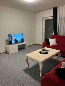 a living room with a couch and a table and a tv at Wohnung in Herford in Herford