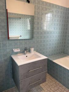 a bathroom with a sink and a tub and a mirror at Wohnung in Herford in Herford +10 photos