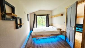 a bedroom with a bed and a window at Eagle's Nest Connemara and Westport in Westport