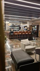 a lobby with chairs and a bar in the background at DolceVita Lux & SPA in Vrnjačka Banja