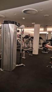 a gym with several treadmills and machines at DolceVita Lux & SPA in Vrnjačka Banja