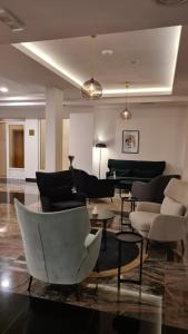 a living room with couches and chairs and tables at DolceVita Lux & SPA in Vrnjačka Banja +24 photos