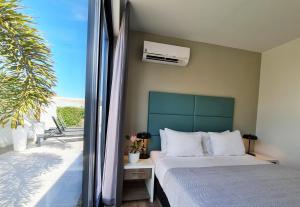 a bedroom with a large bed and a balcony at Tuscany Residence Aruba in Palm-Eagle Beach +277 photos